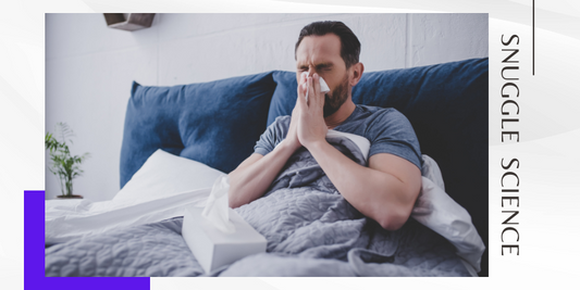 a man with allergies or the common cold or the flu in bed with tissues.